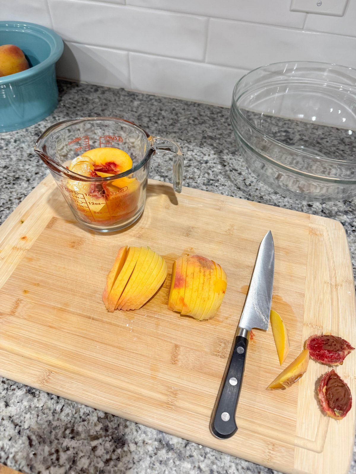cutting peaches on a cutting board.
