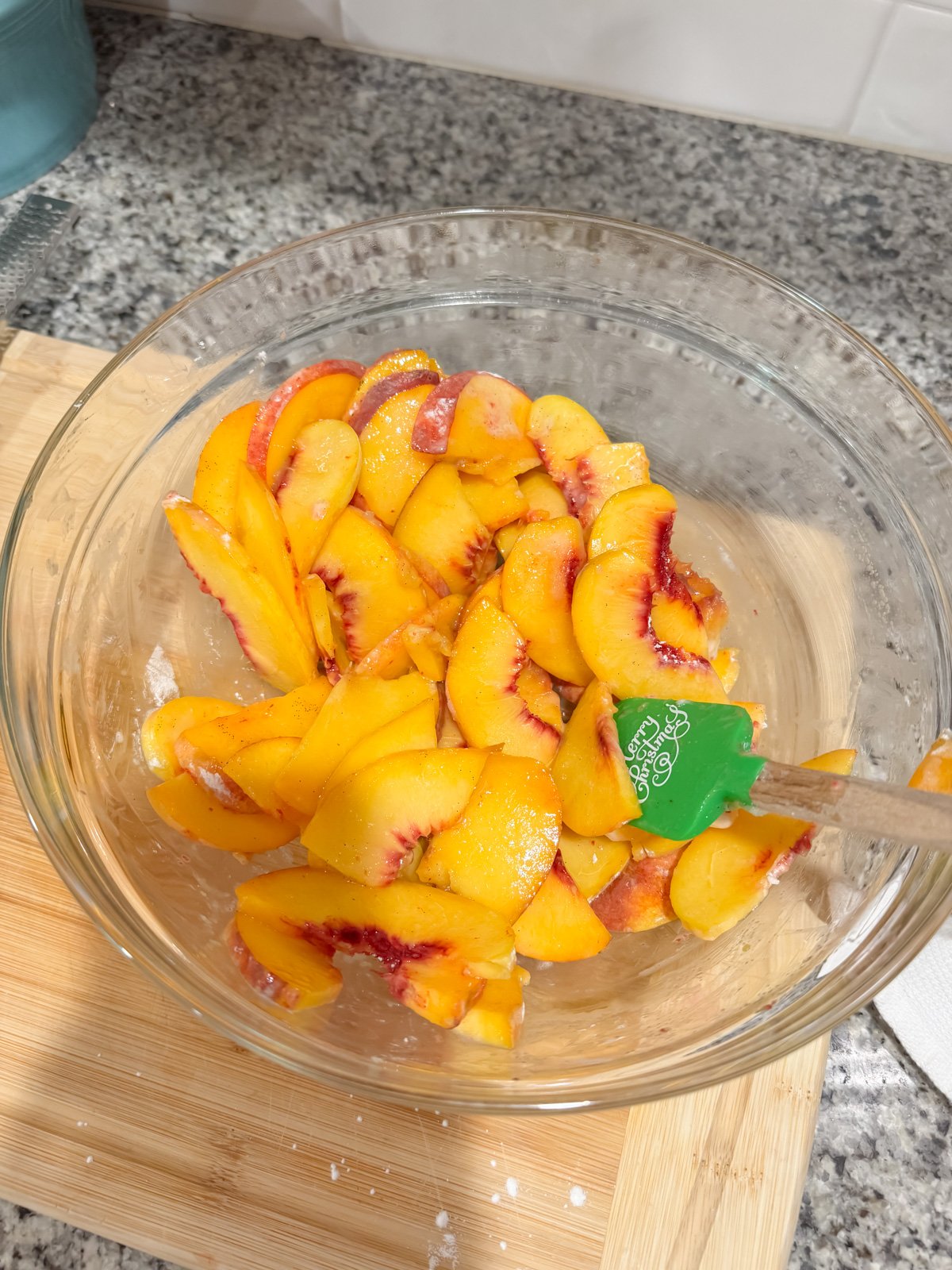 peach filling in a mixing bowl on a kitchen counter.