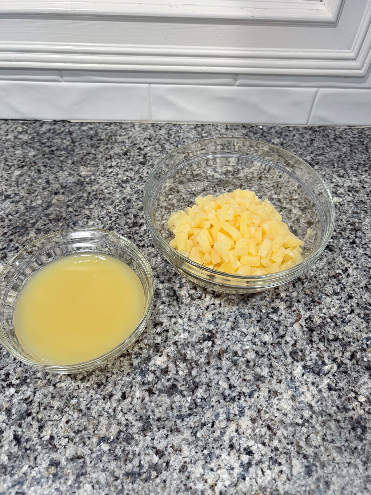 pineapple bits and pineapple juice in 2 separate bowls.