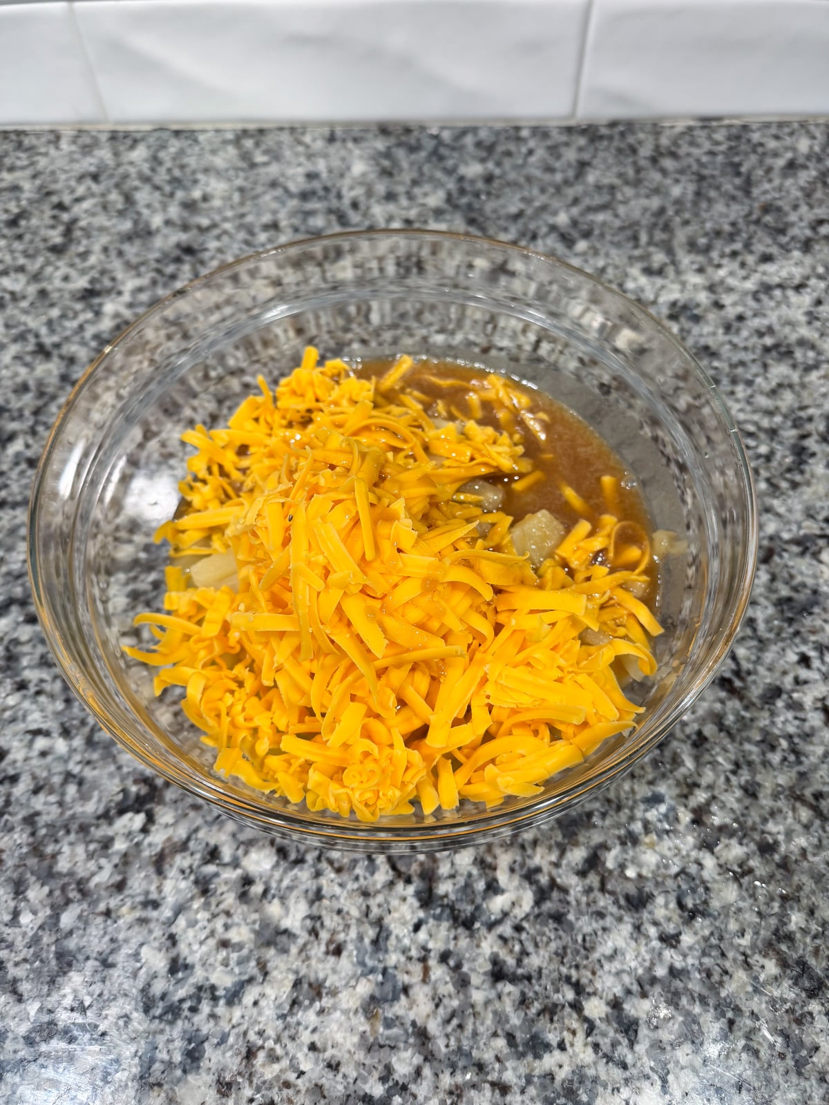 mixing together the base for pineapple cheese casserole.