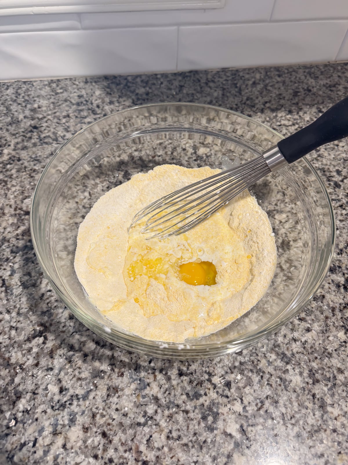 whisking in eggs and buttermilk to flour and cornmeal.