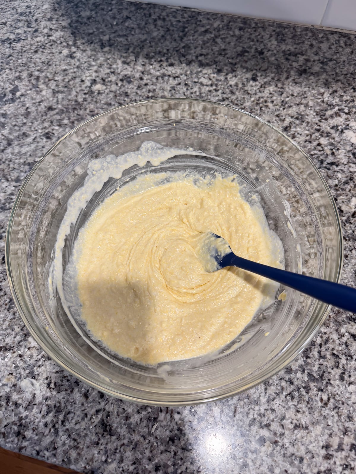 mixing together the batter for hoe cakes in a big mixing bowl.