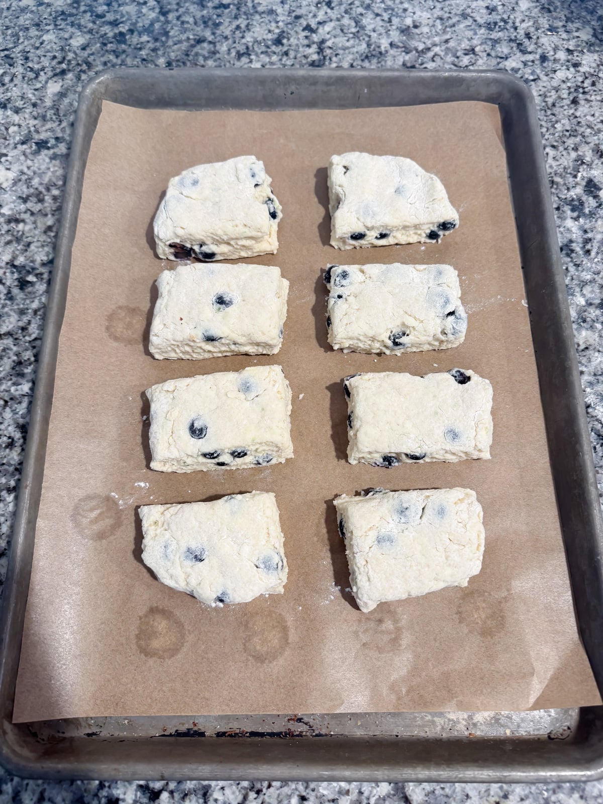 biscuit dough on a baking sheet before going into the oven.