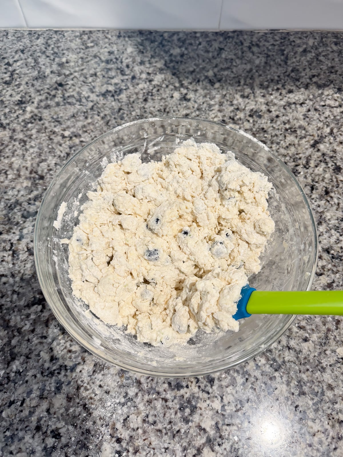 mixing together biscuit dough with a spatula.